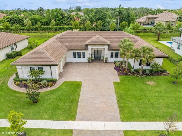 mediterranean / spanish-style home featuring a front yard