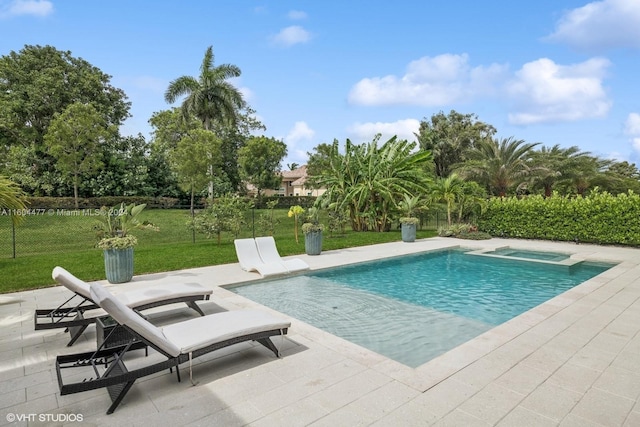 view of swimming pool featuring a lawn and a patio area