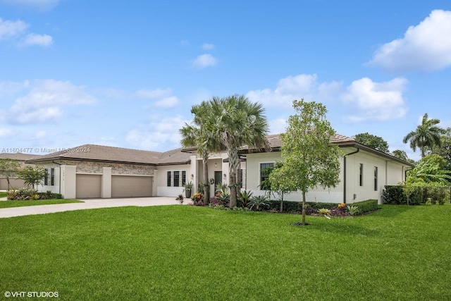 view of front of home with a garage and a front lawn