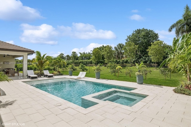 view of pool featuring a yard, an in ground hot tub, and a patio