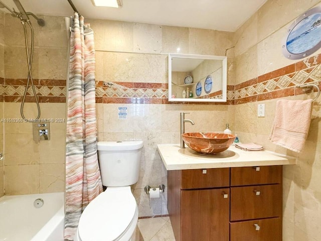 full bathroom featuring vanity, toilet, shower / bathtub combination with curtain, and tile walls