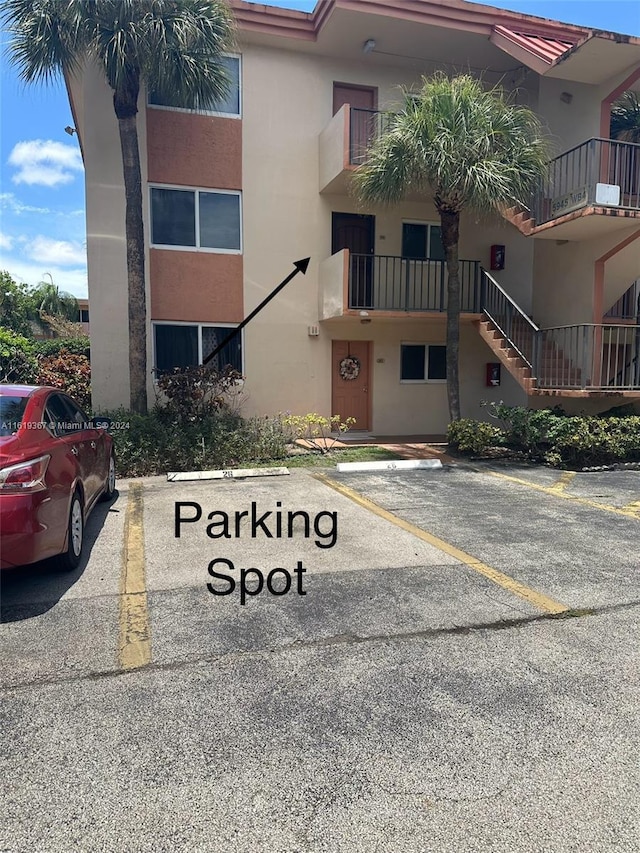 5945 Del Lago Cir Unit 201, Sunrise, FL 33313 - view of building exterior with uncovered parking and stairs