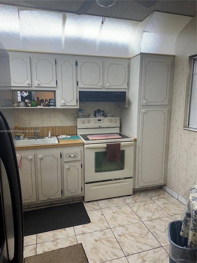 5945 Del Lago Cir Unit 201, Sunrise, FL 33313 - kitchen featuring a sink, wallpapered walls, marble finish floor, electric range, and under cabinet range hood