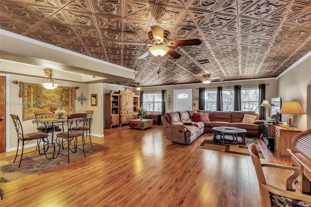 living room with ornamental molding, hardwood / wood-style floors, and ceiling fan