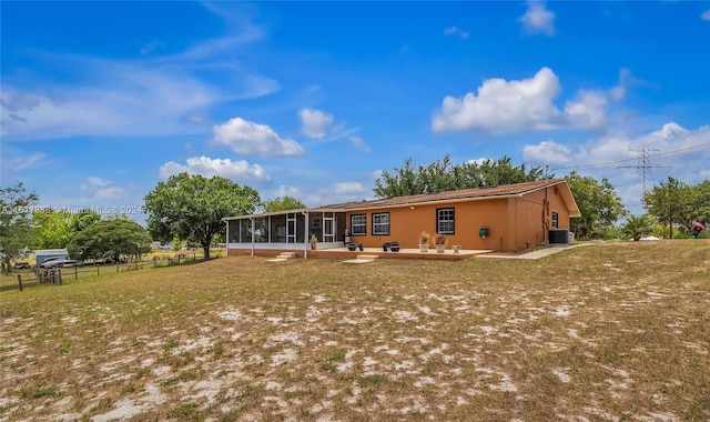 back of house featuring a sunroom, a yard, and a patio area