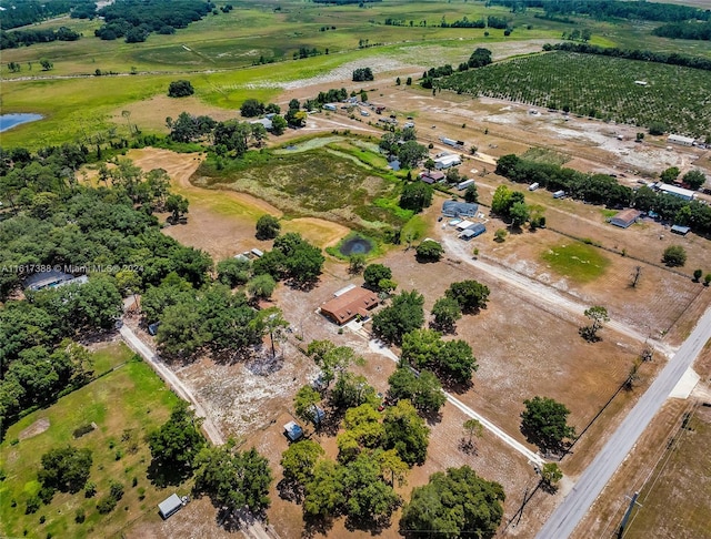 drone / aerial view featuring a water view and a rural view