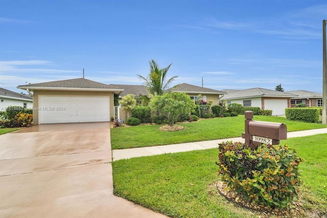 single story home with driveway, a garage, and a front lawn