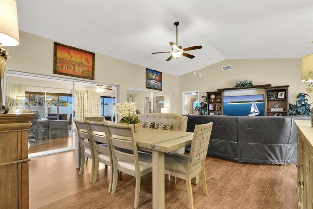 dining room with lofted ceiling, french doors, light hardwood / wood-style flooring, and ceiling fan