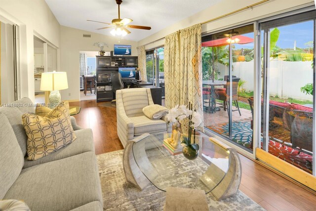 living room featuring ceiling fan and hardwood / wood-style flooring