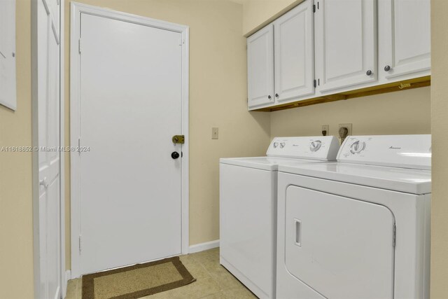 washroom with cabinets, separate washer and dryer, and light tile patterned floors