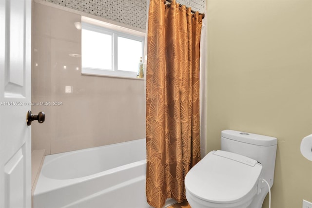 full bathroom featuring shower / bath combo with shower curtain and toilet