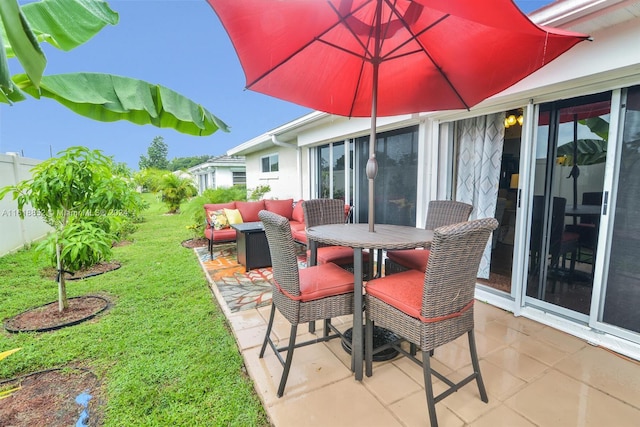 view of patio / terrace with outdoor dining area, outdoor lounge area, and fence