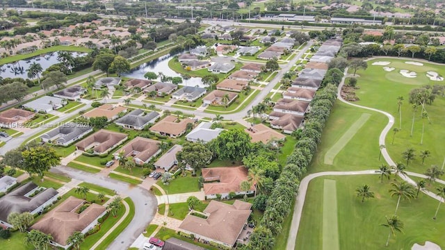 birds eye view of property with a residential view, view of golf course, and a water view