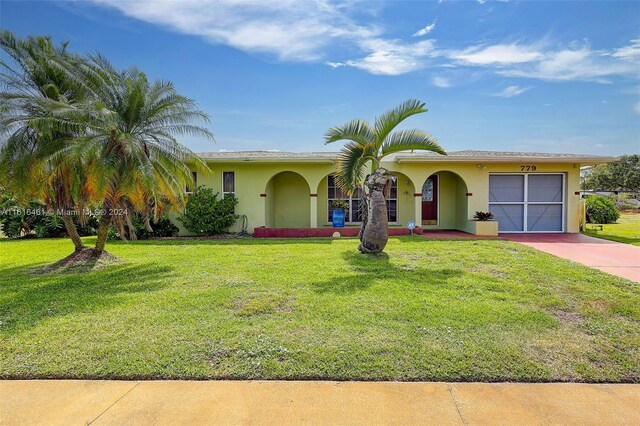 view of front of home with a garage and a front yard