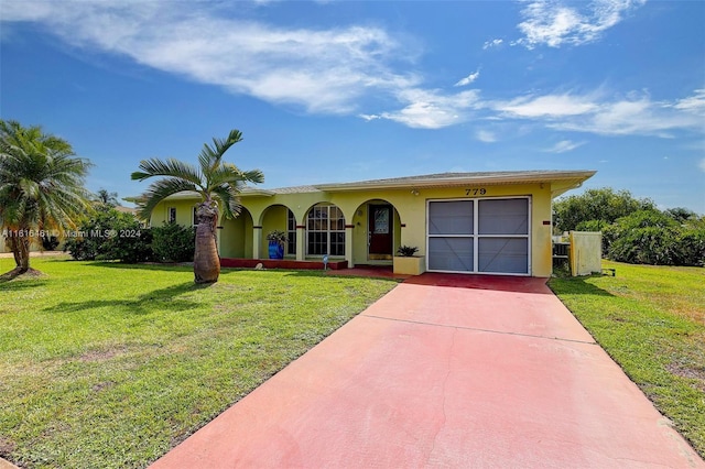 single story home featuring a garage and a front lawn