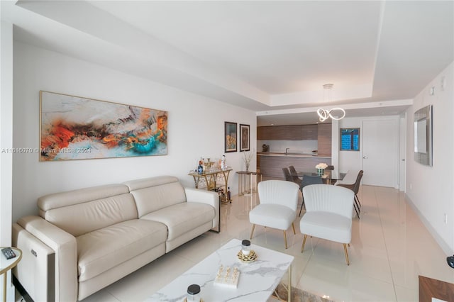 tiled living room featuring a raised ceiling