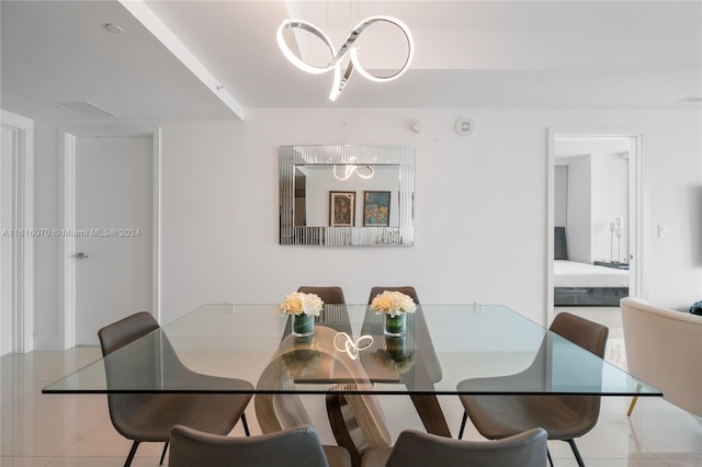 dining room with an inviting chandelier and tile patterned flooring