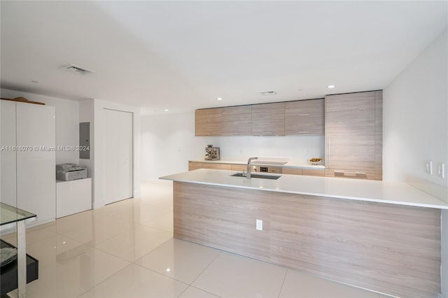 kitchen with light tile patterned flooring and sink