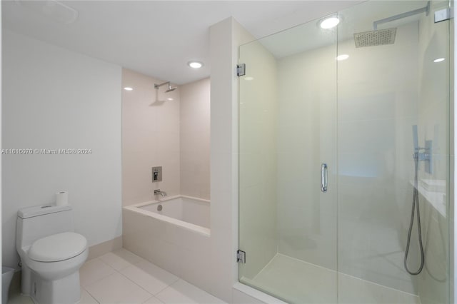 bathroom featuring shower with separate bathtub, tile patterned floors, and toilet