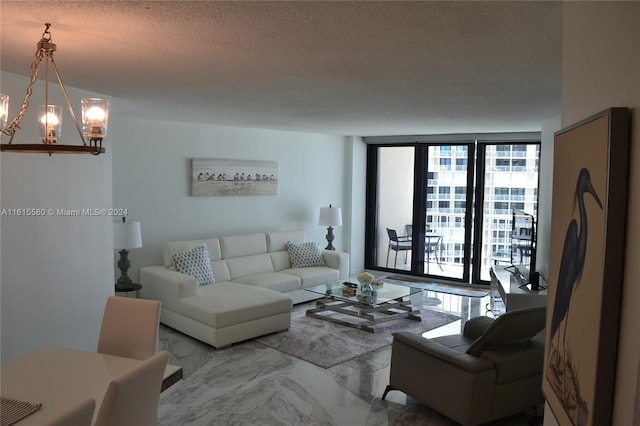 living room with a chandelier, floor to ceiling windows, and a textured ceiling