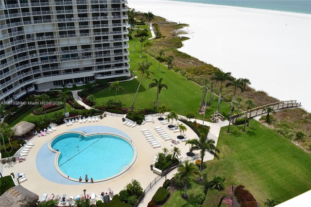 aerial view with a water view and a beach view