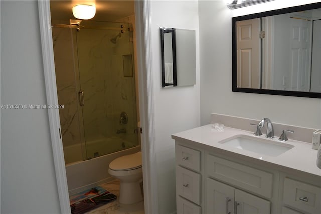 full bathroom with vanity, toilet, and combined bath / shower with glass door