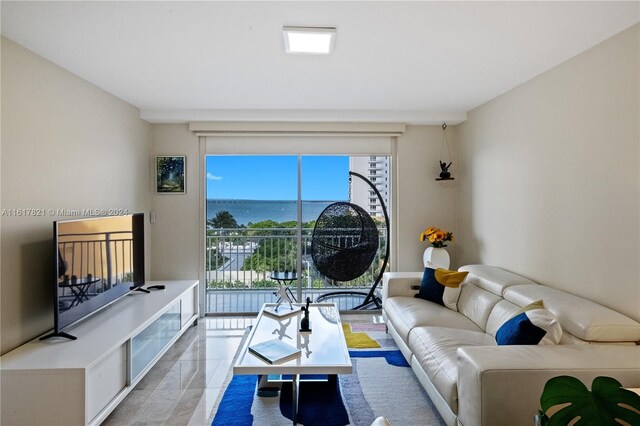 tiled living room with a water view