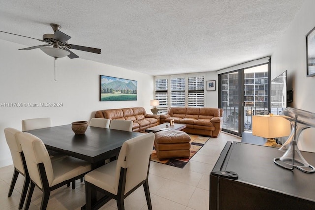 dining room with a textured ceiling, ceiling fan, and light tile patterned floors