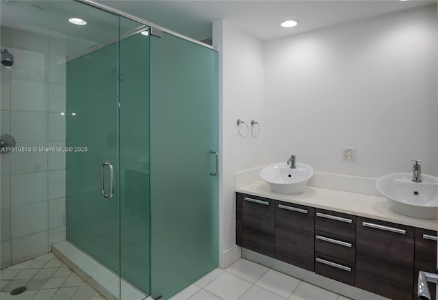 bathroom with tile patterned flooring, vanity, and a shower with shower door