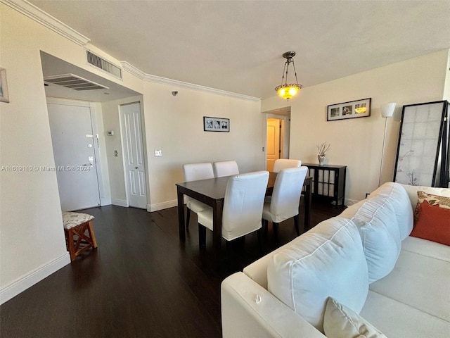 dining area with dark hardwood / wood-style flooring and crown molding