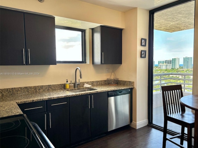 kitchen featuring sink, dishwasher, dark hardwood / wood-style flooring, and a healthy amount of sunlight