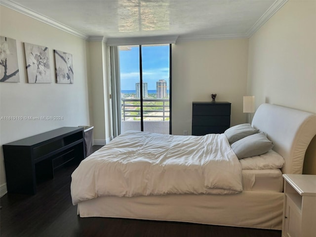 bedroom with dark hardwood / wood-style flooring, crown molding, and access to outside