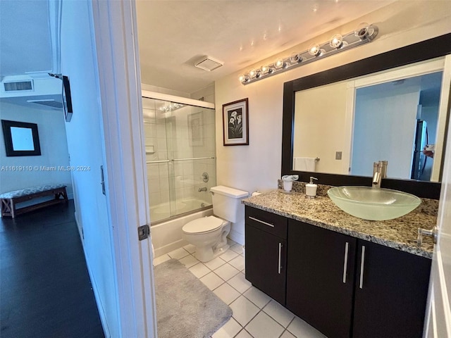 full bathroom featuring toilet, enclosed tub / shower combo, vanity, and tile patterned floors