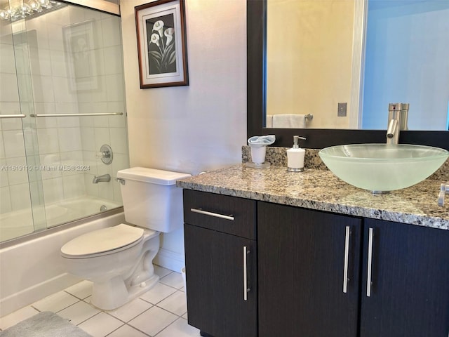 full bathroom featuring toilet, tile patterned floors, vanity, and shower / bath combination with glass door