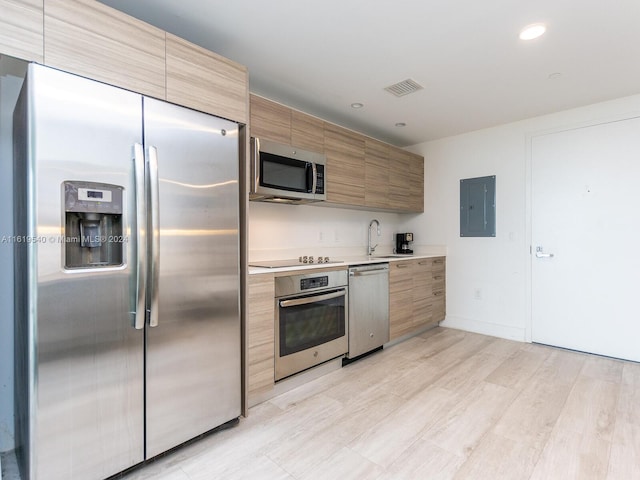 121 NE 34th St Unit 1014, Miami, FL 33137 - kitchen with light hardwood / wood-style floors, electric panel, stainless steel appliances, and sink
