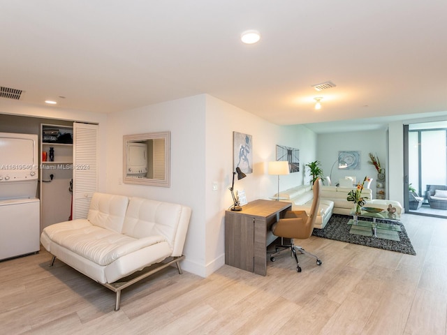 121 NE 34th St Unit 1014, Miami, FL 33137 - home office featuring stacked washer / drying machine and light hardwood / wood-style floors
