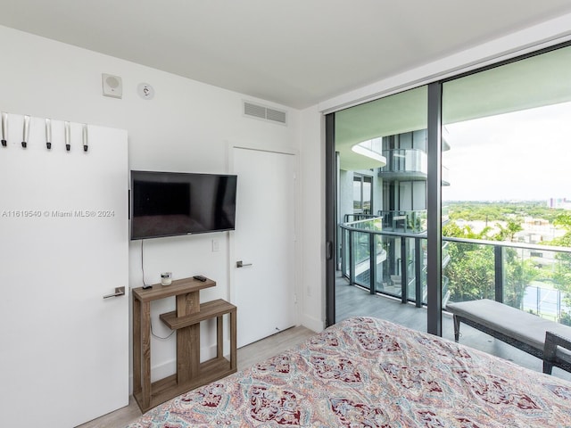 121 NE 34th St Unit 1014, Miami, FL 33137 - bedroom featuring light hardwood / wood-style flooring and floor to ceiling windows