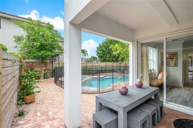 view of patio / terrace with a fenced in pool