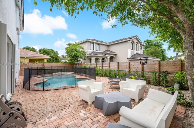 view of patio featuring a fenced in pool and outdoor lounge area