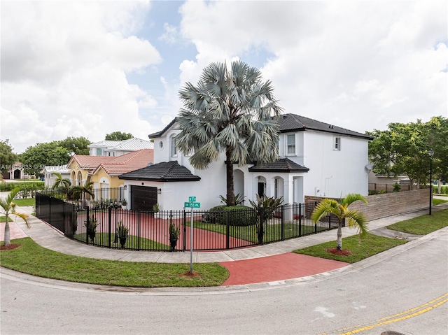 view of front facade featuring a front lawn, a fenced front yard, and stucco siding