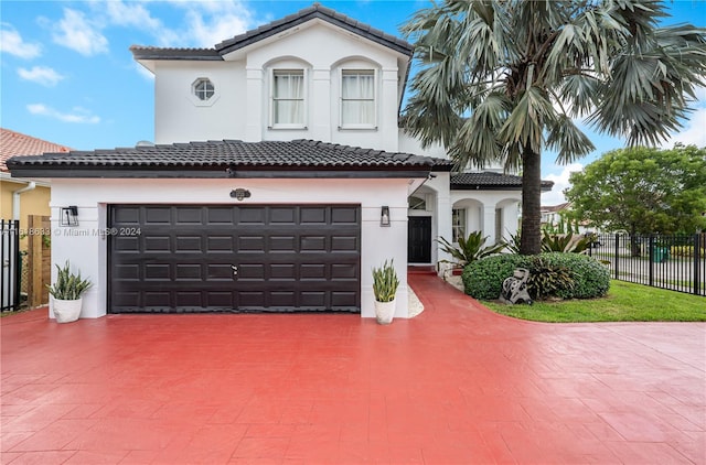 mediterranean / spanish-style home with a garage