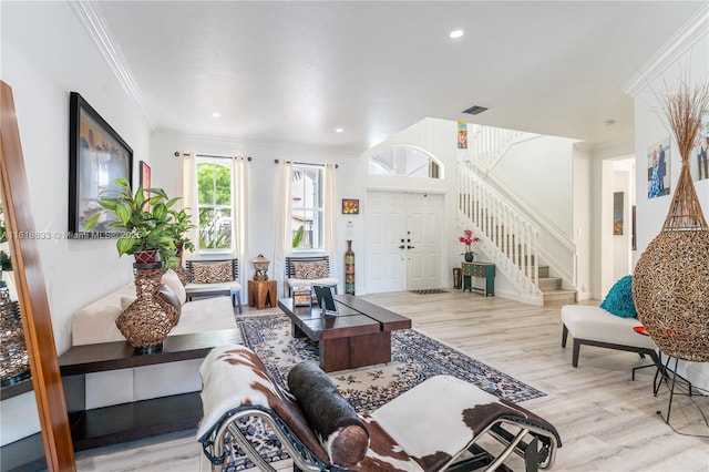 living room featuring recessed lighting, visible vents, ornamental molding, wood finished floors, and stairs