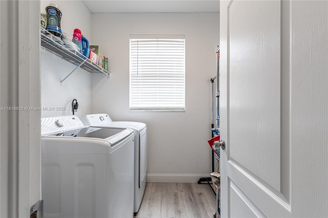 laundry room with laundry area, light wood-style flooring, baseboards, and washer and dryer