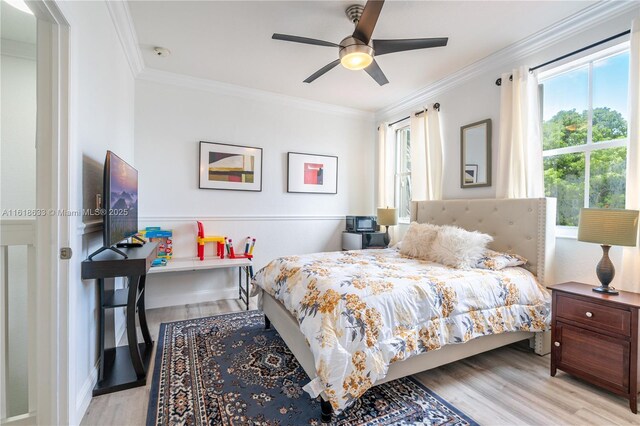 bedroom featuring light wood-type flooring, ceiling fan, and crown molding