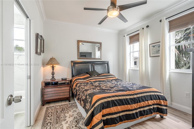 bedroom with ornamental molding, connected bathroom, and ceiling fan