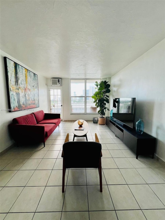 living room featuring light tile patterned floors and a textured ceiling