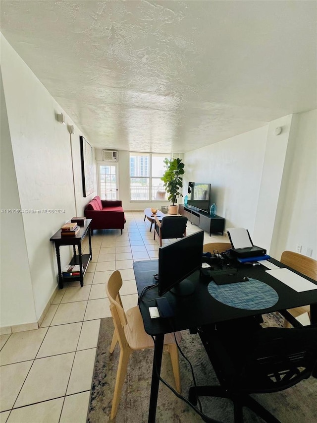 tiled dining area featuring a textured ceiling