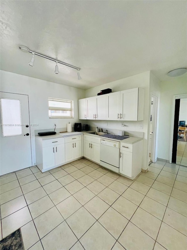 kitchen featuring white cabinetry, light tile patterned floors, sink, and dishwasher