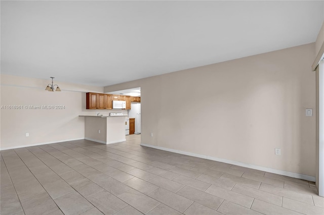 unfurnished living room featuring light tile patterned floors and a chandelier