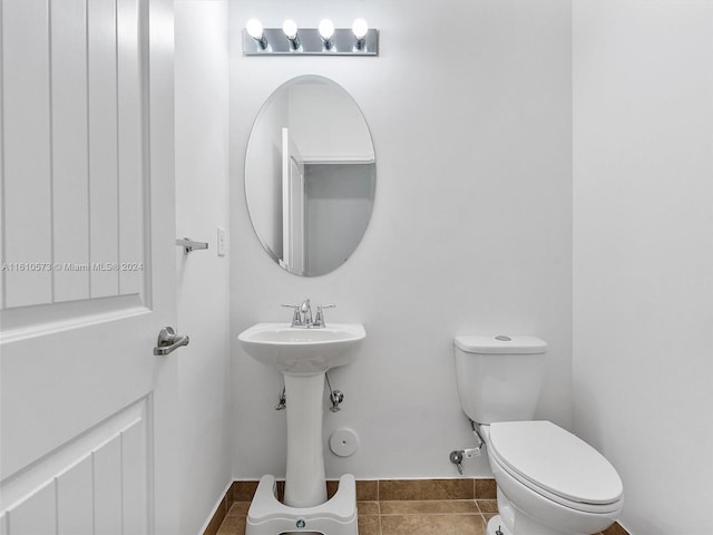 bathroom with toilet and tile patterned floors